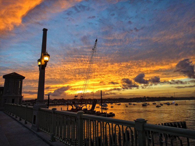 Sunset behind crane barge removing temporary bridge of lions