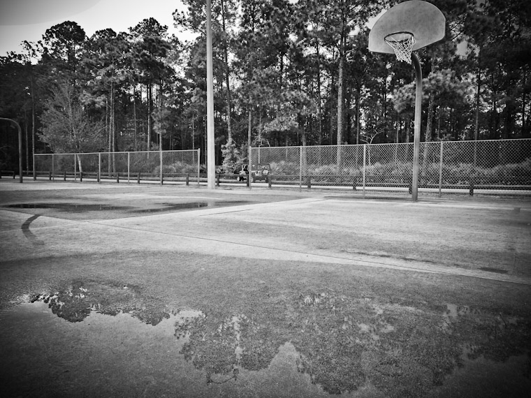 Puddle Reflection at Treaty Park of basketball hoop