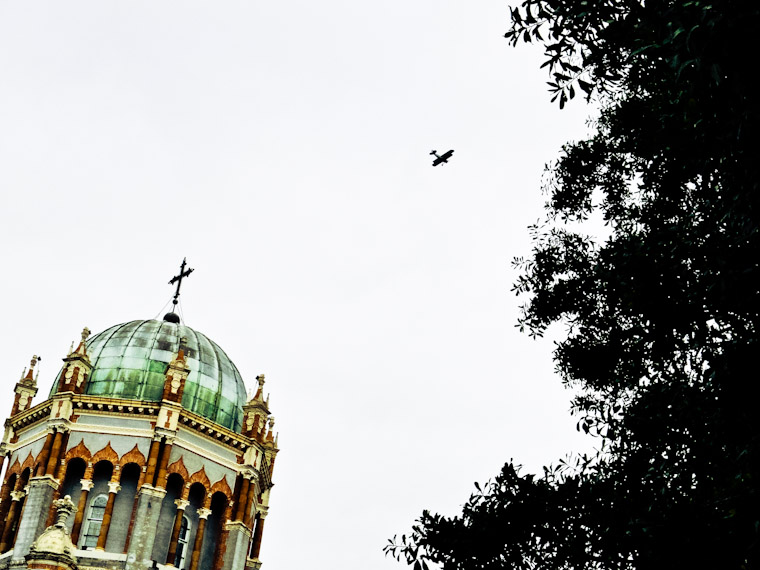 Biplane flying over memorial presbyterian dome