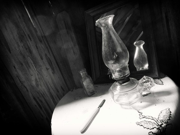 Oil lamp and knife on table in cracker house at Florida Agricultural museum