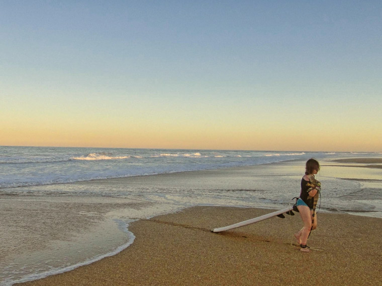 Surfing with an iguana lizard on a leash