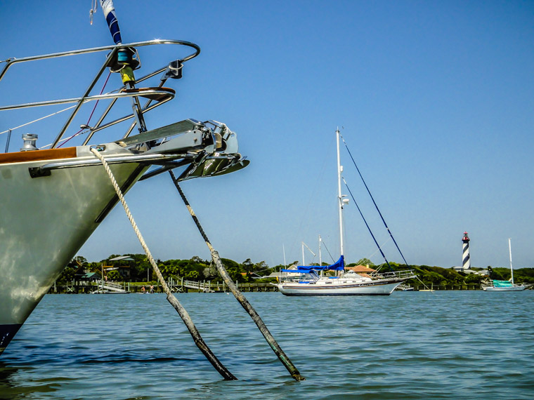 Kayaking intracoastal by boats and lighthouse