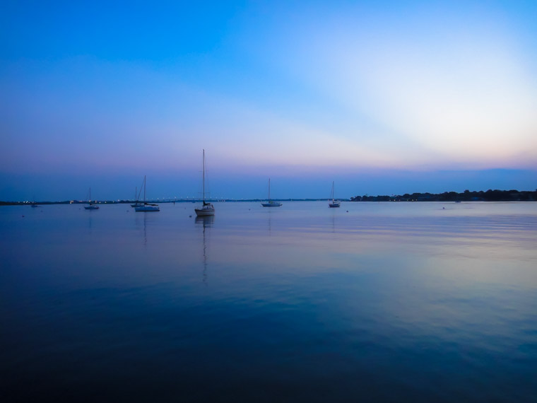 Sunrise boats on bayfront sky