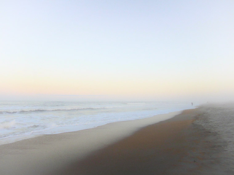 Beach misty fog waves sunset