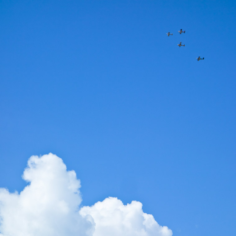 Airplanes in formation with blue sky and clouds